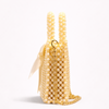 Yellow beaded handbag with a ribbon on a white background