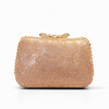 Gold glittery clutch bag on a white background