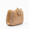 Gold clutch bag with decorative elements on a white background